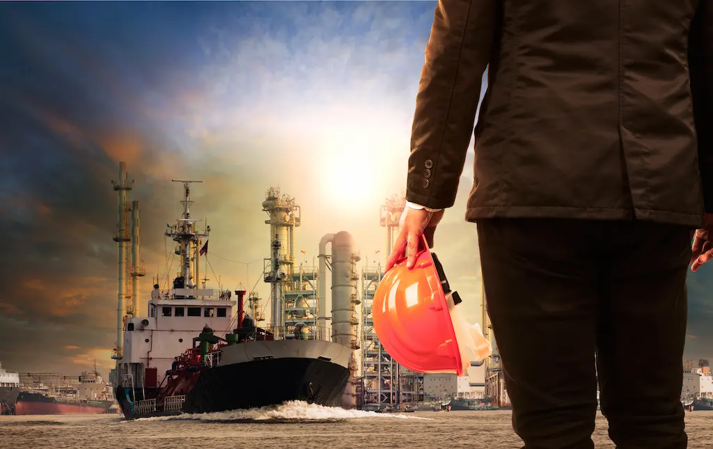 A man standing and a ship cruising on background